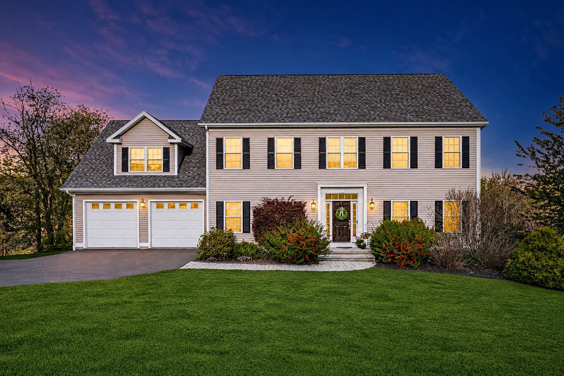 Twilight real estate photograph of a two-story Connecticut home